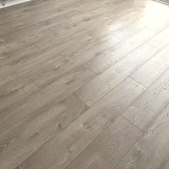 Smooth plywood underlayment installed in a bay‑windowed room, offering a flat, stable base ready for engineered or solid hardwood flooring.